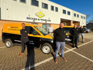Team and vans outside Brooks & Wood building